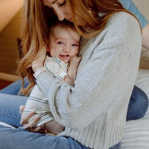 Mom hugging her baby wearing Bonsie's Old School Romper.